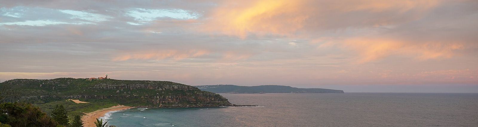 Barrenjoey Headland and lighthouse above North Palm Beach at dusk